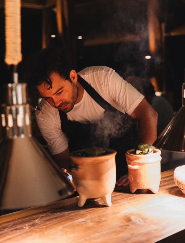 Chef gilberto briceño preparing a gourmet dish